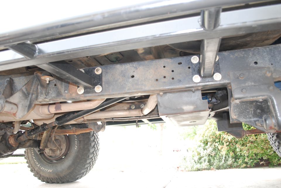 Undercarriage of lifted 4x4 showing frame, exhaust, driveshaft, skid plate and BFGoodrich Mud-Terrain tire