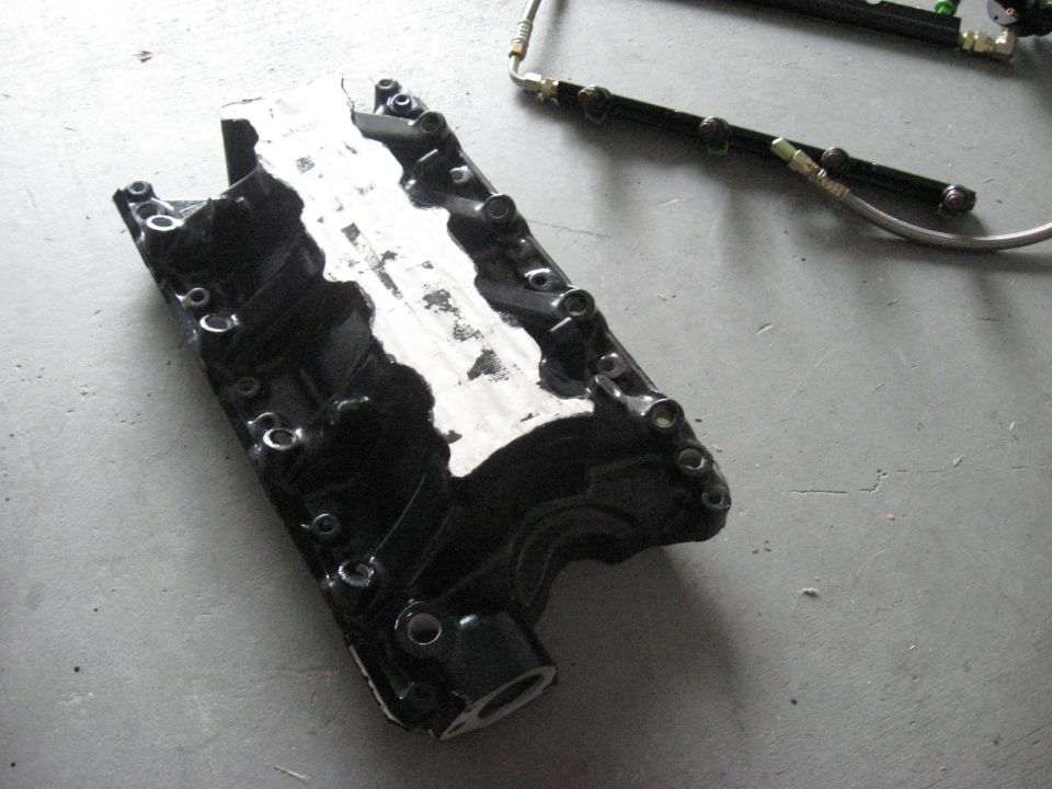 Engine intake manifold and fuel rail assembly on a concrete floor