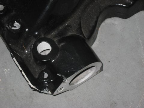 1991 Ford Bronco - A close-up view of a black metal automotive part with visible machining and mounting points.