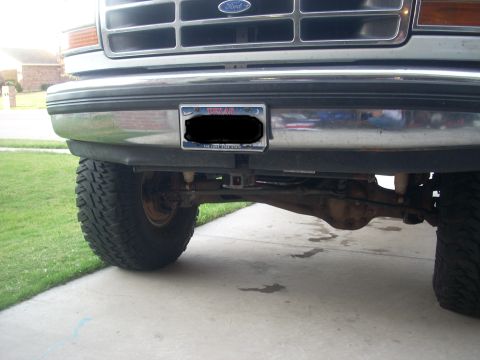 1992 Ford Bronco - Close-up of the front of a Ford truck, showing the grille, bumper, and front suspension components.