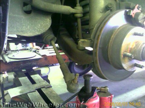 1985 Ford Mustang - Front suspension components are visible, including a brake rotor and tie rod end.