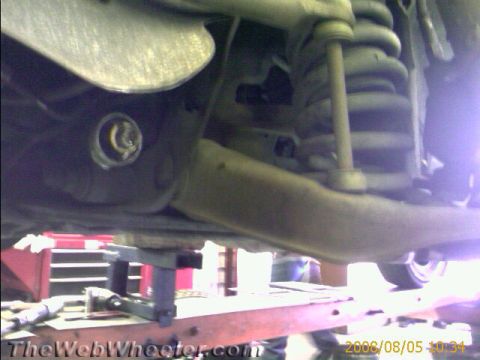 1985 Ford Mustang - Underside view of a vehicle's suspension system, showing various mechanical components.