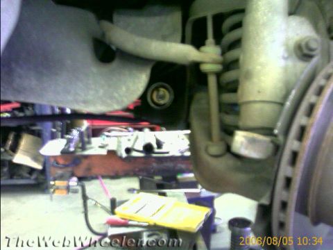 1985 Ford Mustang - Close-up view of automotive suspension components, likely during maintenance or repair.