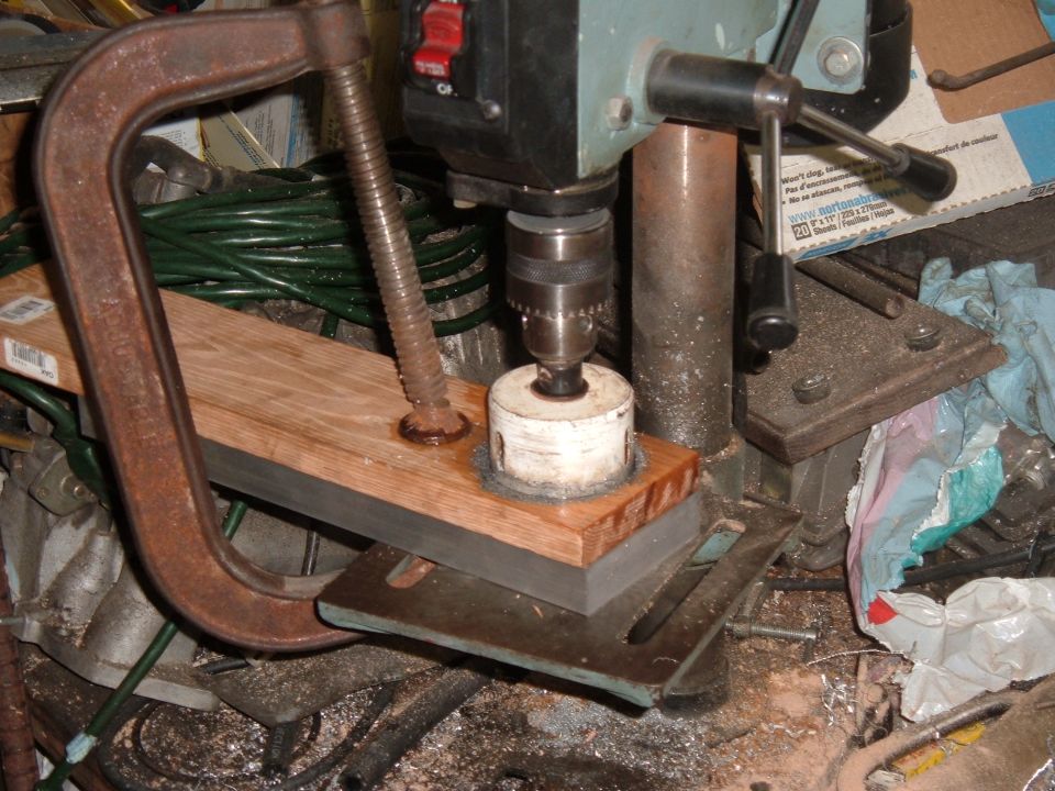 All set up to bore out the center hole. everything is clamped down so it won't move around. See how the wood supports the hole saw.