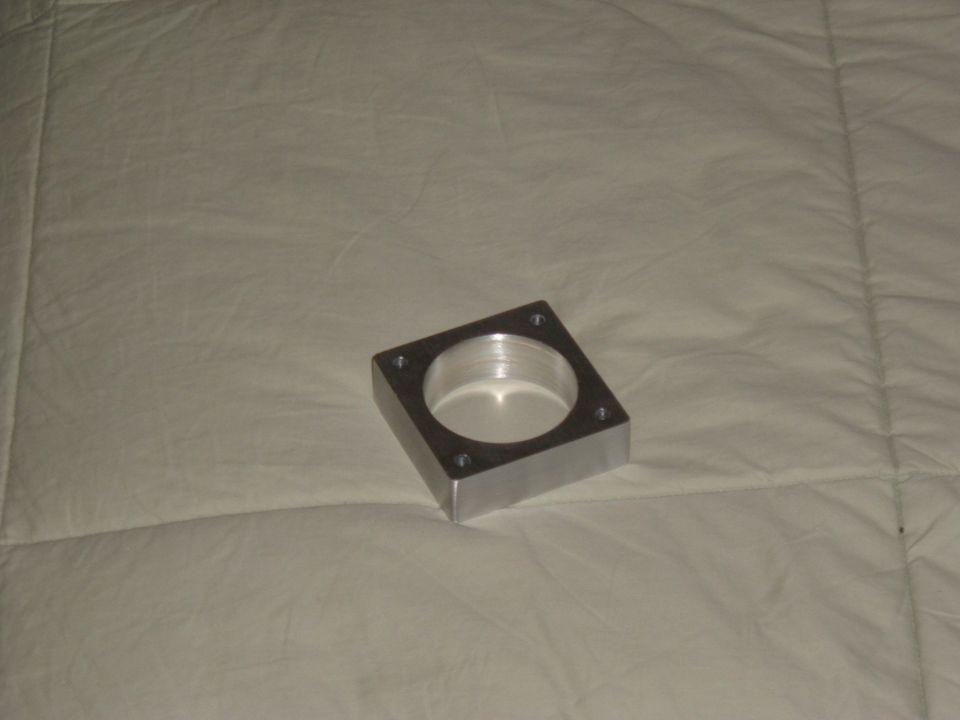 So I got carried away and finished with no more pictures. I filed and ground and sanded the sides until they were smooth and square. Then I marked, center punched and drilled the four mounting holes. Last, I lightly sanded all the surfaces to remove any ridges from the machining. Looks good, I'll make some 1" stands from 5/8" hex stock to space out the throttle cable bracket to match.