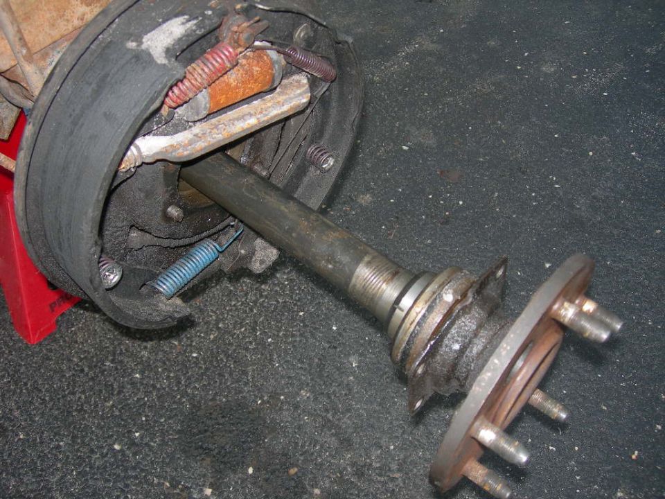 Disassembled drum brake assembly and axle shaft