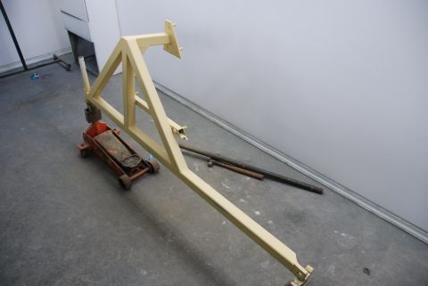 1996 Ford Bronco - Photograph of a welded steel engine-hoist frame and floor jack in a shop, not a technical document.