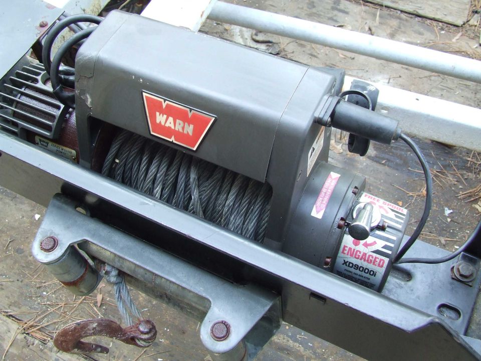 Warn XD9000i winch with red WARN logo and steel cable