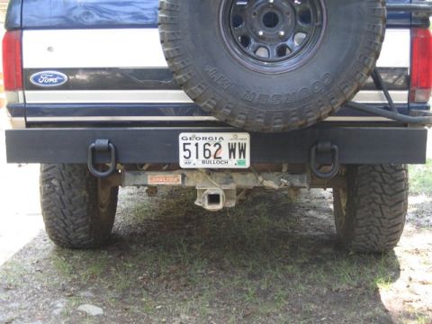 1995 Ford Bronco - The rear of a Ford Bronco shows a spare tire, custom bumper, and a Georgia license plate.