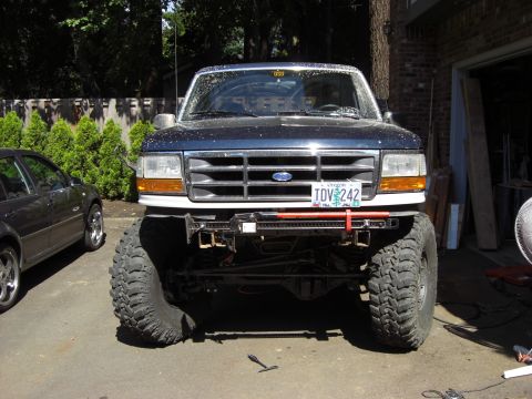 1993 Ford Bronco - This modified Ford Bronco has oversized tires and a front winch, suggesting off-road use.