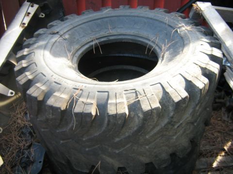 1990 Ford Bronco - A single, large off-road tire is shown, not a 1990 Ford Bronco.
