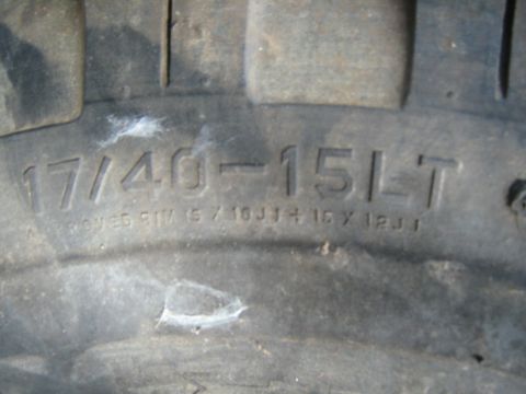 1990 Ford Bronco - The tire sidewall displays size information and approved rim dimensions.