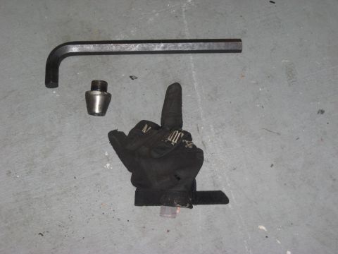 1991 Ford Bronco - Tools and a glove are laid out on a concrete surface.