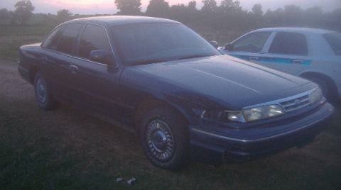 1997 Ford Crown Victoria - This 1997 Ford Crown Victoria is seen from a 3q-front angle, with another vehicle partially visible behind it.