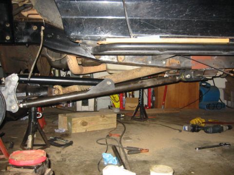 1995 Ford Bronco - Vehicle is on jack stands with suspension components visible, suggesting modification or repair work.