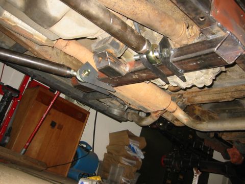 1995 Ford Bronco - Custom suspension parts and exhaust visible from underneath a vehicle.