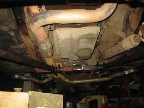 1995 Ford Bronco - This photo shows the undercarriage of a vehicle, focusing on the transmission and exhaust components.