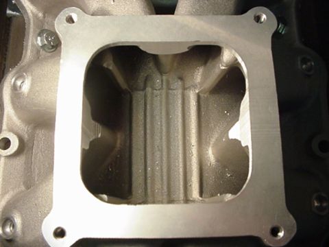 1979 Ford Bronco - This is a close-up view of an engine's intake manifold, showing its internal structure and gasket mating surface.