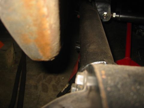 1995 Ford Bronco - Undercarriage view of a vehicle, showing suspension parts and some rust.