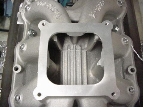 1979 Ford Bronco - Close-up of an aluminum intake manifold, showing its internal structure and mounting flange.