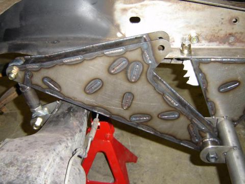 1984 Ford Bronco - A close-up view of a custom-welded suspension component, likely for an off-road vehicle, is shown.