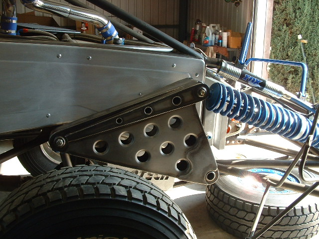 Cantilever rocker plate and blue FOX coilovers on a bare-metal tube-chassis off-road buggy