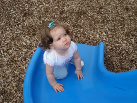 2000 Ford Crown Victoria - Baby on a blue playground slide.