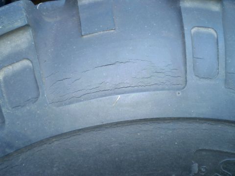 1979 Ford Bronco - Tire tread exhibits extensive cracking, indicating wear and potential failure.