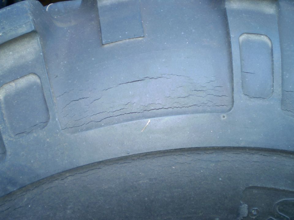 Close-up of a tire tread showing significant cracking