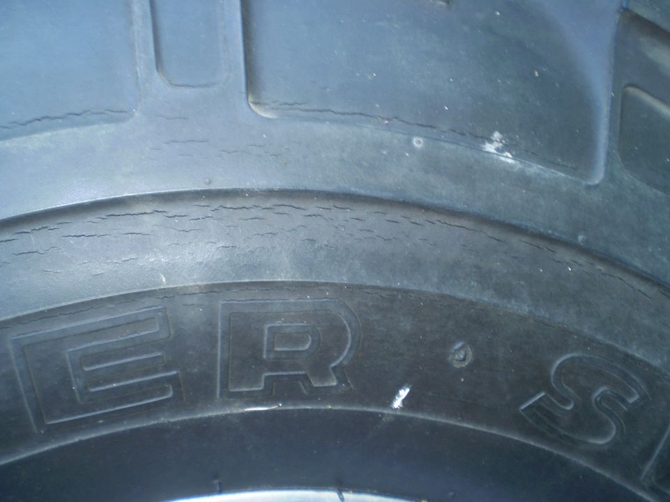 close-up of a tire with visible cracking on the sidewall