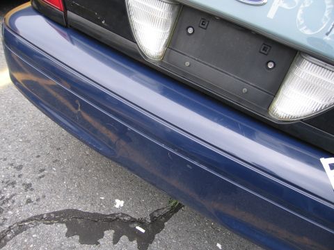 2001 Ford Crown Victoria - Rear view of a blue 2001 Ford Crown Victoria, showing the bumper and taillight.