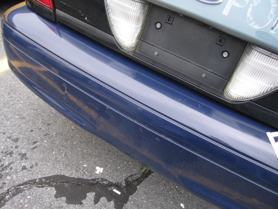 Blue rear bumper and taillight of a 2001 Ford Crown Victoria