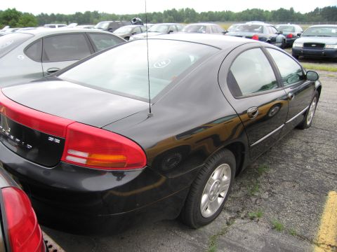 2001 Ford Crown Victoria - A black sedan is parked in a lot with several other vehicles visible in the background.
