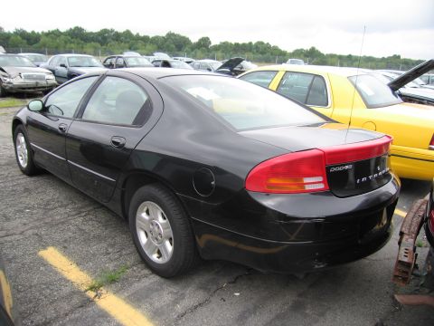 2001 Ford Crown Victoria - Rear view of a black Dodge Intrepid sedan parked in a lot with other vehicles.