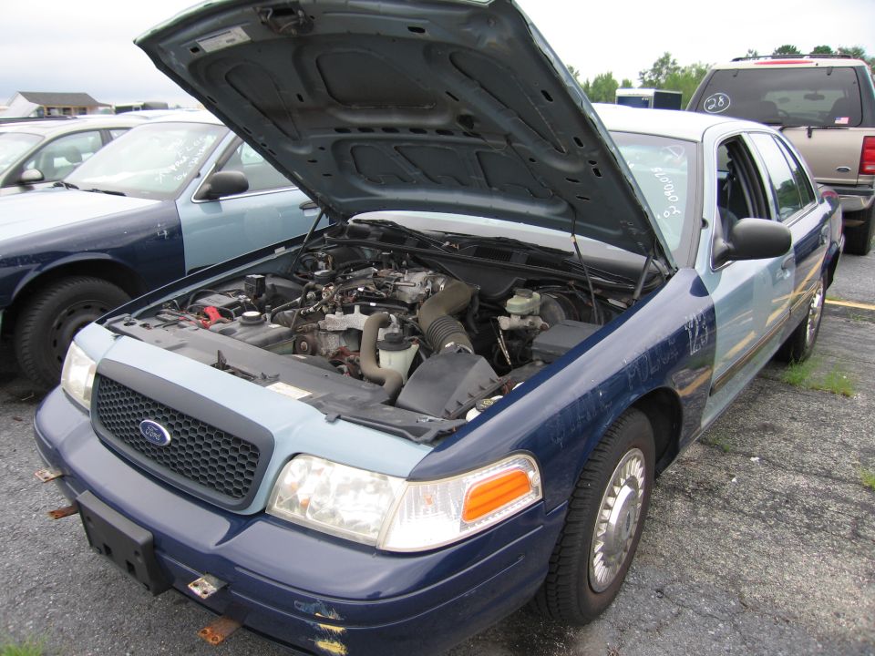2001 Ford Crown Victoria, front 3/4 view with hood open, showing engine