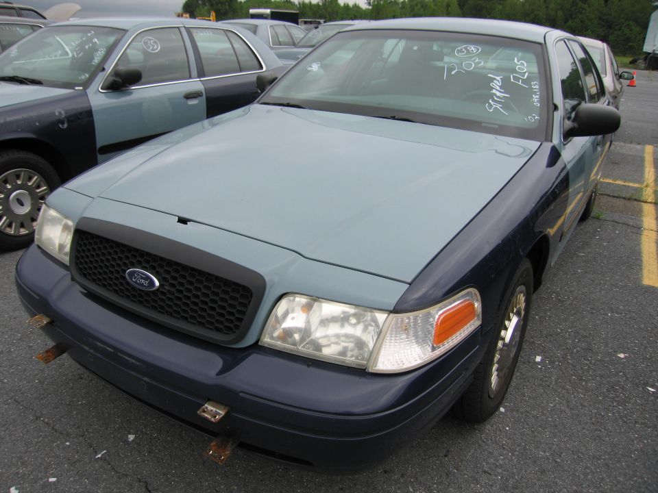 Front view of a two-tone blue 2001 Ford Crown Victoria with a black grille