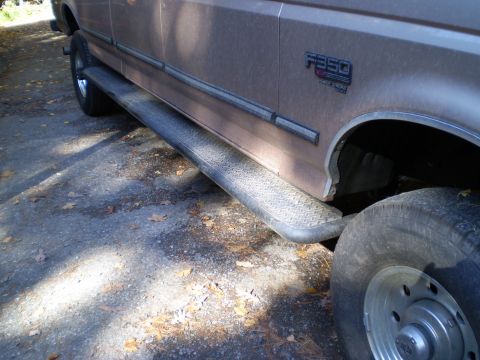 1979 Ford Bronco - Side view of a brown Ford F350 truck, showing its running boards and a large tire.