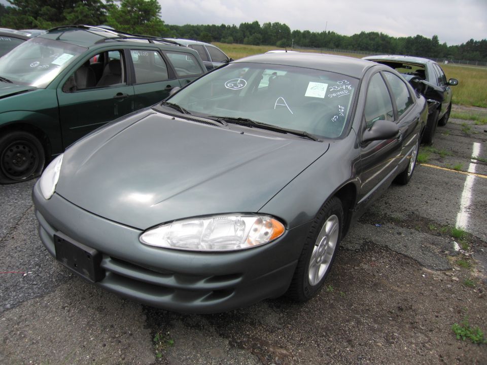 Dark gray sedan with a "03 2348" sticker on windshield, parked next to a green wagon