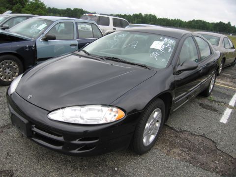 2001 Ford Crown Victoria - A black sedan is parked in a lot with other vehicles visible in the background.