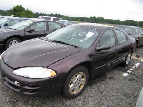 2001 Ford Crown Victoria - A dark purple sedan is parked in a lot with other vehicles visible in the background.