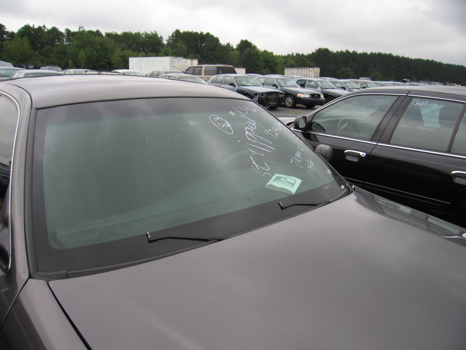 2001 Ford Crown Victoria windshield with chalk writing and a sticker