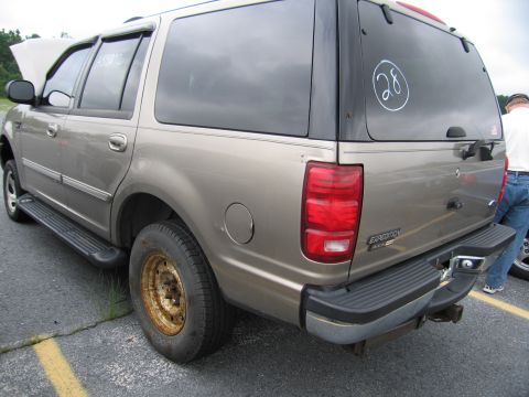 2001 Ford Crown Victoria - This Ford Expedition SUV has a tow hitch and a cap on the rear window with a circled number.
