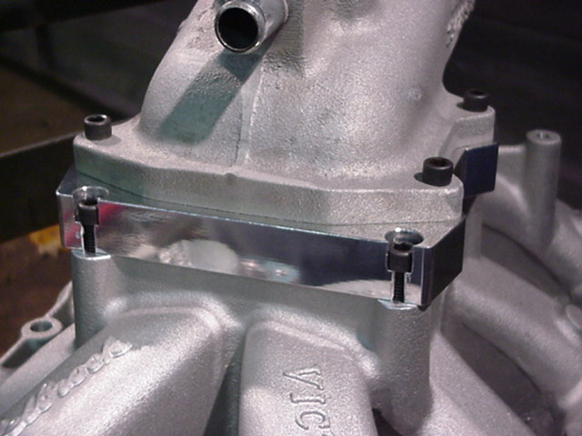 Aluminum intake manifold with a polished metal spacer and black bolts