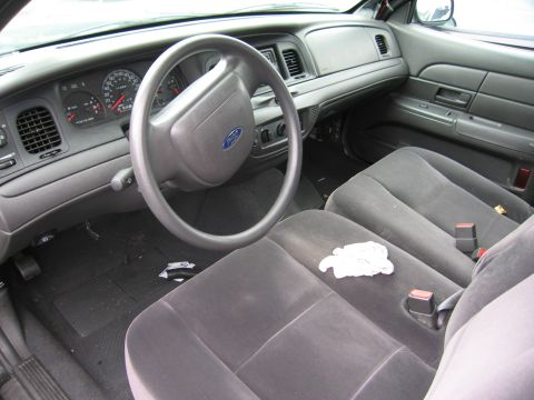 2001 Ford Crown Victoria - The interior of a 2001 Ford Crown Victoria, a gray dashboard and cloth seats.