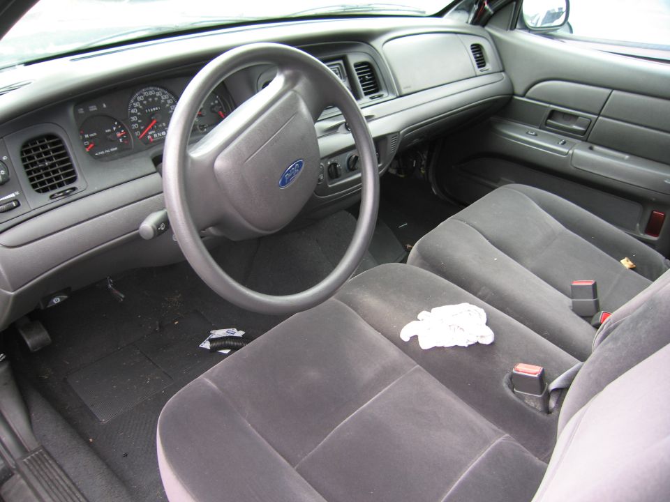 Interior of a 2001 Ford Crown Victoria, showing dashboard, steering wheel, and front seats
