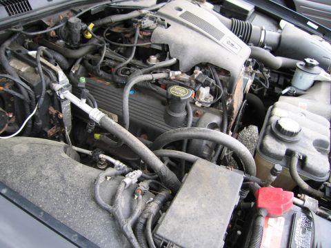 2001 Ford Crown Victoria - Close-up view of a vehicle's engine bay, showing various hoses, wires, and engine components.