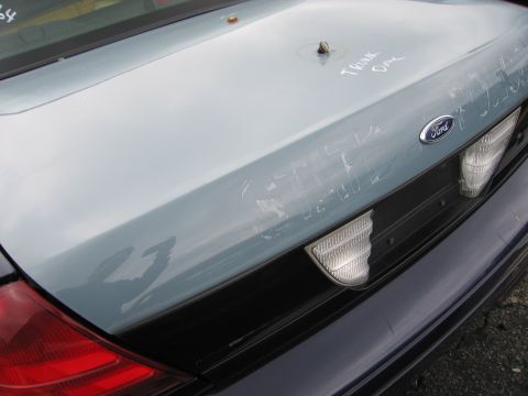2001 Ford Crown Victoria - Rear view of a 2001 Ford Crown Victoria, showing the Ford emblem and handwritten notes on the trunk lid.