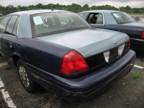 2001 Ford Crown Victoria - Photo of a blue Ford Crown Victoria's rear with white auction markings on the glass.