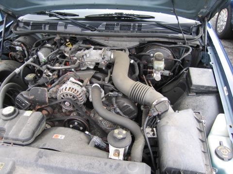 2001 Ford Crown Victoria - Photograph of a Ford engine compartment showing the intake, alternator and belts.
