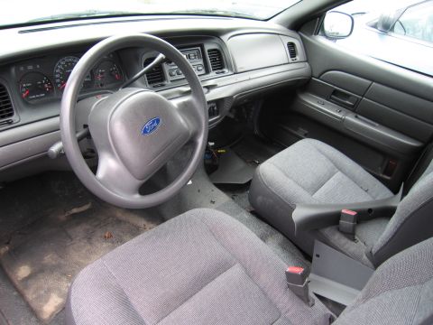 2001 Ford Crown Victoria - Photo of a Ford Crown Victoria interior with steering wheel, dash and cloth seats.